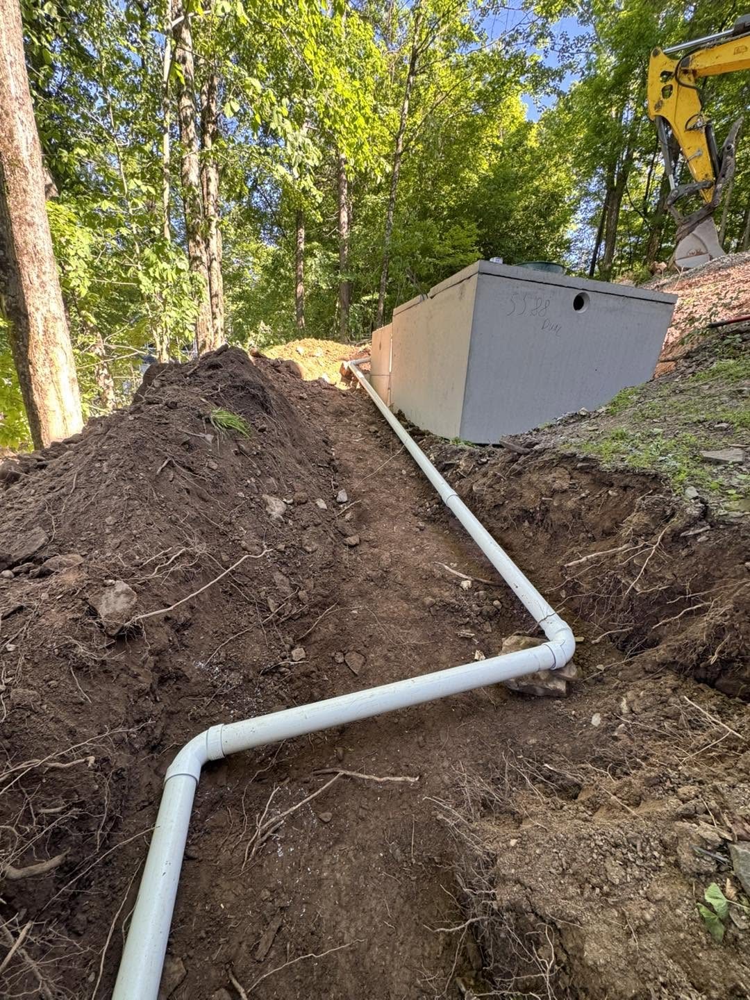 Septic tank installation in wooded property
